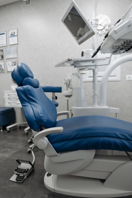 Clean, modern dental chair and equipment in a bright clinic office