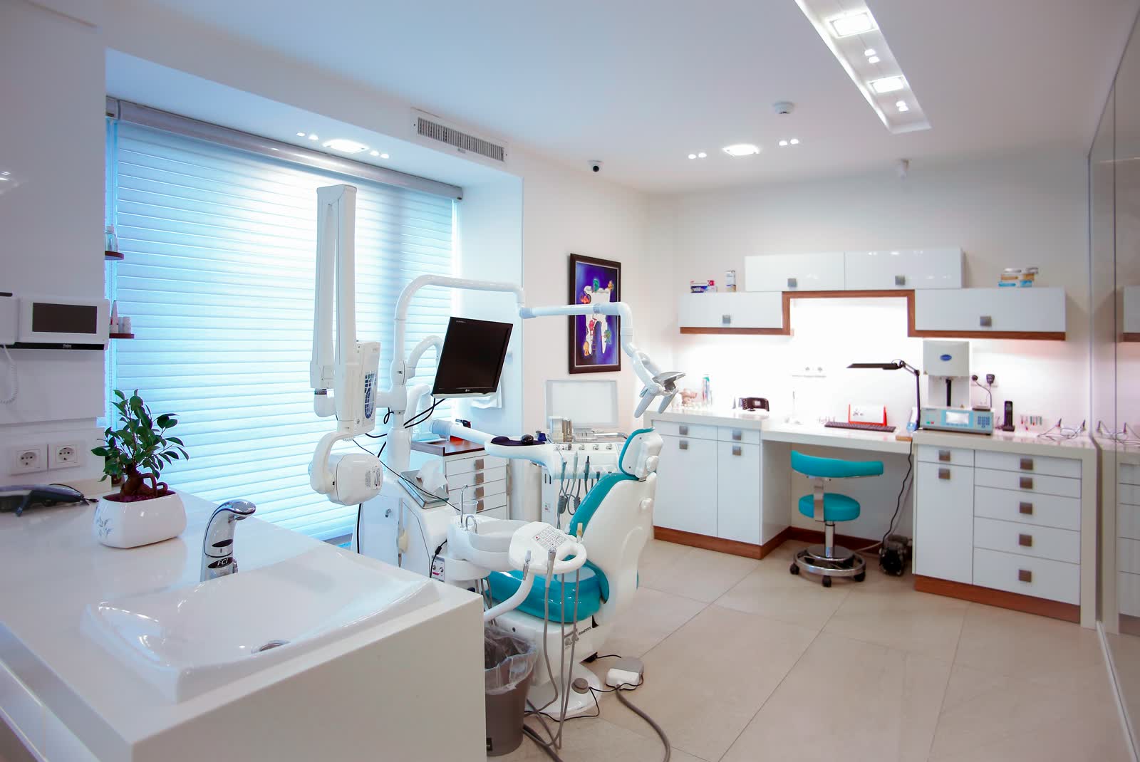 Bright, modern dental operatory with teal and white finishes